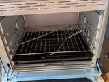 an open oven with a rack in the middle of it