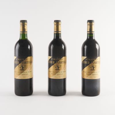 trois bouteilles de vin sont alignées sur une surface blanche