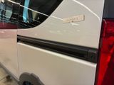 a white van parked in a parking lot with its door open