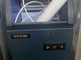 a blue machine that is sitting in the corner of a room