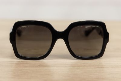 a close up of a pair of black sunglasses on a table
