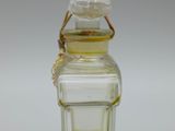 an image of a small glass bottle with a brown liquid inside of it