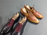 three pairs of shoes sitting on top of a table next to each other