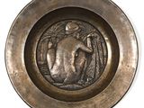 a bronze plate with a picture of a woman in the center of it