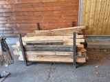a pile of wood sitting on the ground next to a building