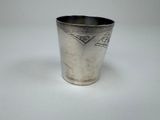 a silver cup that is sitting on a table