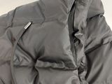 the back of a grey puffer jacket with a zippered hood