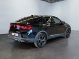 the rear end of a black suv in a showroom