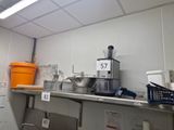 a kitchen with a lot of clutter on the counter