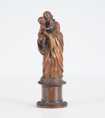 a bronze statue of a woman holding a child on a pedestal