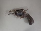 a gun that is on a table with a white background