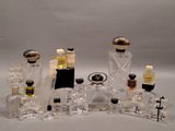 many bottles of perfume sitting on a white surface