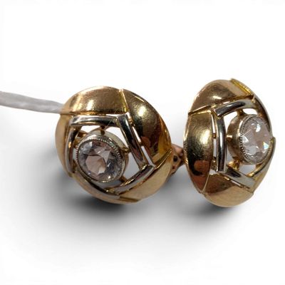 pair of diamond stud earrings on a white surface with a white background