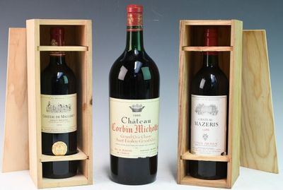 two bottles of red wine in wooden cases on a table