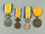 three medals and a medal are sitting on a table