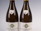 two bottles of wine sitting next to each other on a table