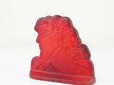 an image of a red candle with a woman ' s face