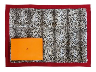 a close up of a leopard print bag with an orange box