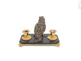 a statue of a bird sitting on top of a candle holder
