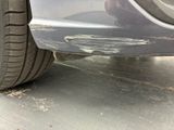 a close up of a car ' s front bumper with scratches on it