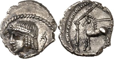 a silver coin with an image of a woman wearing a headdress