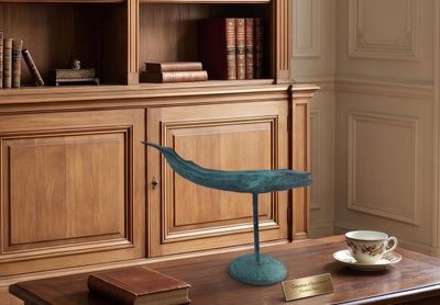 a wooden table with a blue bird on top of it