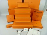 an orange box with a small bag and a pair of scissors