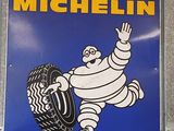 a blue sign with a picture of a cartoon character holding a tire
