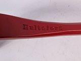 an image of a red plastic toothbrush with a black handle