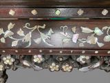 a close up of a wooden table with flowers on it