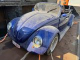 a blue car that is parked on the side of the road