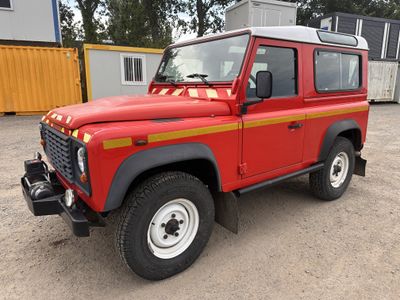 a picture of a red land rover parked in a lot