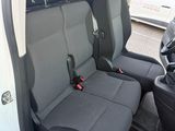 two seats in the back of a van with a steering wheel