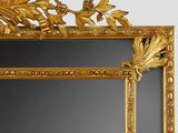 a mirror with a gold frame on the wall