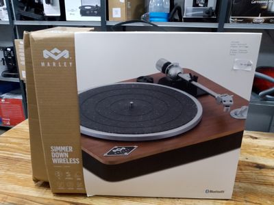 an open box of a record player sitting on top of a wooden table