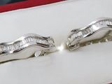 pair of white gold earrings with baguets of diamonds in a gift box