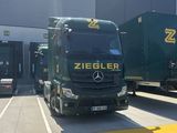 deux camions garés devant un immeuble