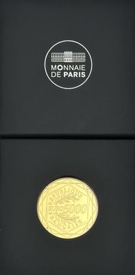 a close up of a gold coin in a black box