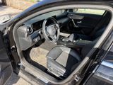 the interior of a car with the door open showing the steering wheel and dashboard
