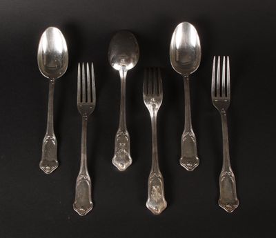 five silver spoons and a fork on a black surface