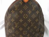 a close up of a brown louis vuitton bag on a white background
