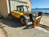 a picture of a construction vehicle parked in front of a building