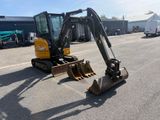 a small excavator that is parked in the parking lot