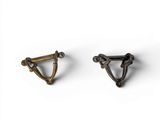 a pair of brass ear clips on a white background