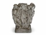a stone sculpture of a group of people on a pedestal