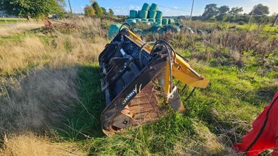 a bulldozer that is sitting in the middle of a field