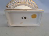 a small white plate with a gold rim on it