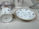 many different types of porcelain dishes and cups on the table