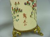 a vase with flowers on it sitting on a stand