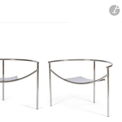 pair of chrome steel lounge chairs with white leather seats